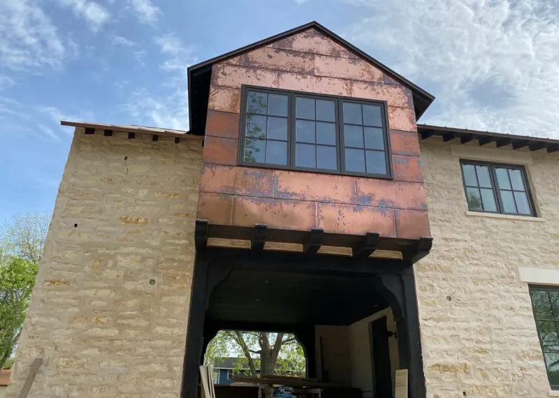 Copper metal panel facade on a stone building for Skylight Installation in Midlothian
